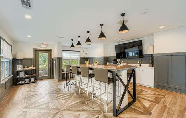 A kitchen with a large island and a dining table.