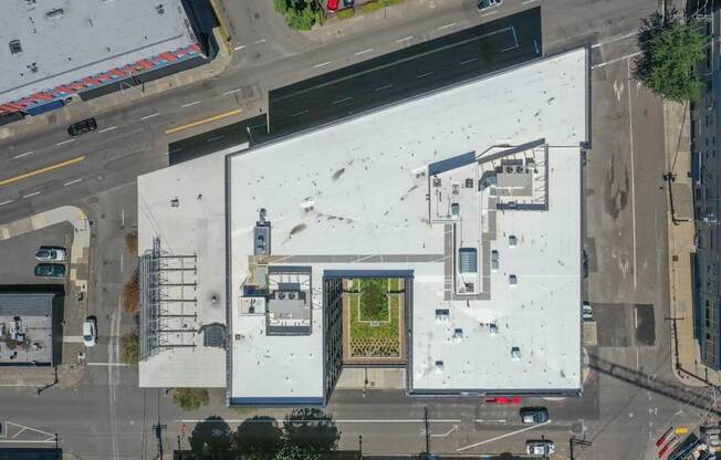 An aerial view of a building with a white roof and a yellow door.