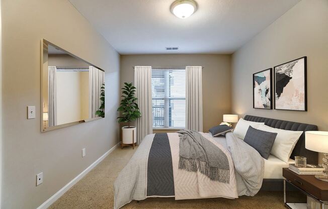 a bedroom with a bed and a mirror
