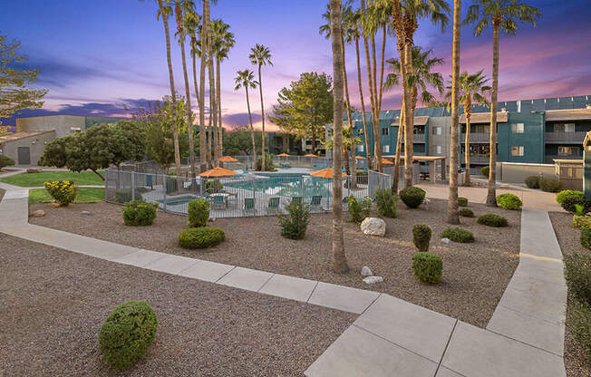 Community Swimming Pool with Pool Furniture at Tanque Verde Apartments located in Tucson, AZ.