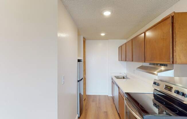 a kitchen with white countertops and wood cabinets