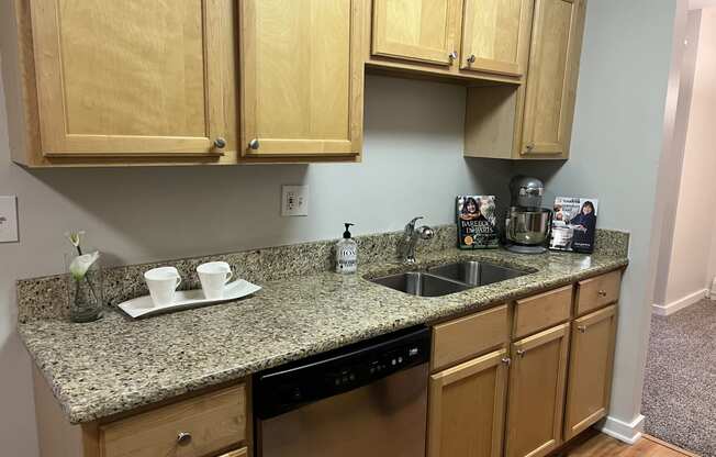 a kitchen with granite counter top and wooden cabinets