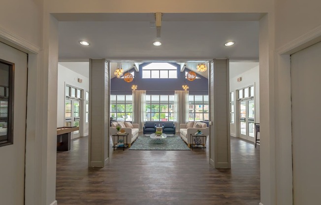 a hallway with geometric patterns on the ceiling and a wood floor