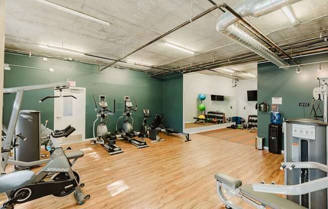 A gym with a variety of exercise equipment.