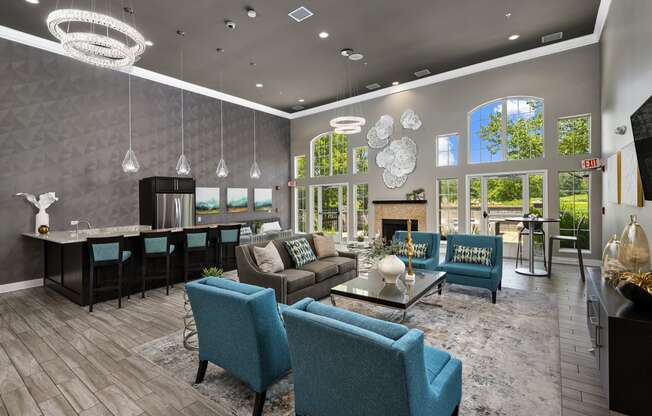 a living room with couches and chairs and a kitchen with a fireplace