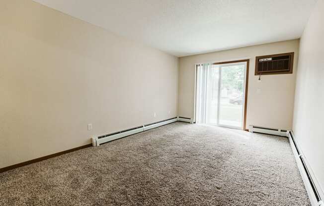 Grand Forks, ND Grandview II Apartments. A living room with a glass sliding door