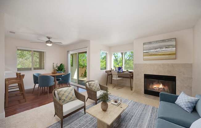 a living room with a fireplace and a table with chairs