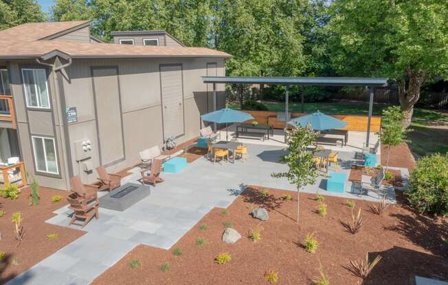 an aerial view of a patio with umbrellas and chairs