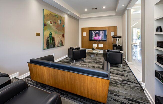 A modern living room with a couch, chair, and television.