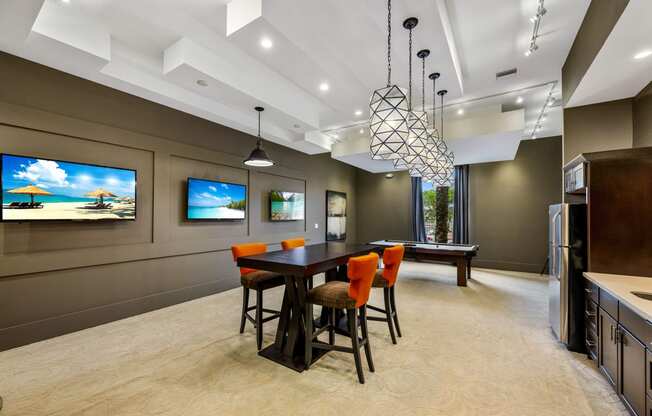a kitchen and dining room with a table and chairs and a television