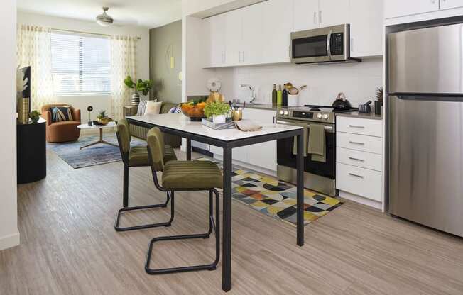 a kitchen and dining room with a table and chairs