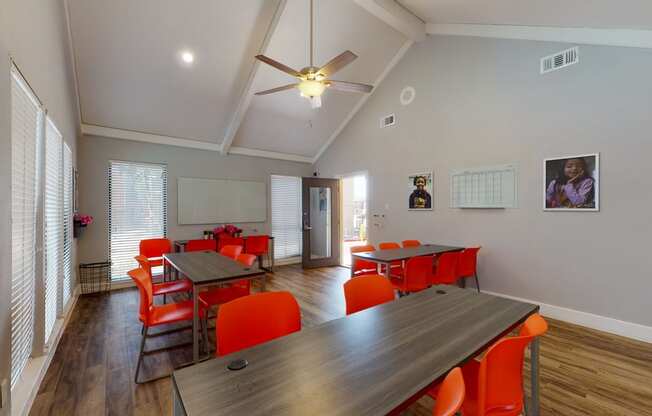 a dining room with tables and chairs and a ceiling fan