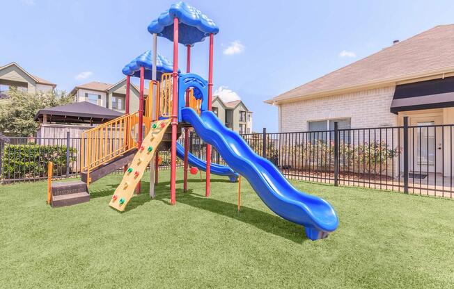 Childrenâs play area with blue slide at The Avenue apartmentsÂ 