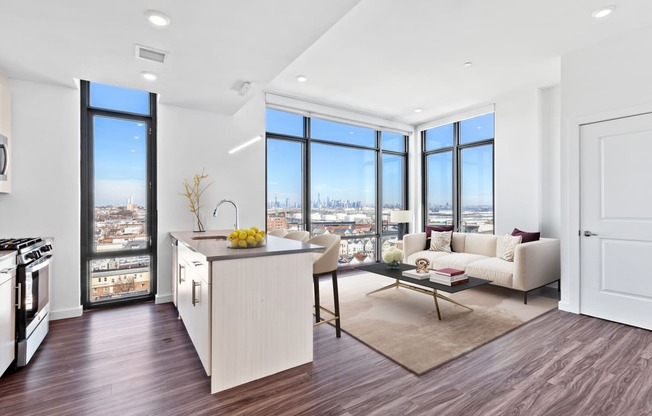 an open living room with a kitchen and a view of the city