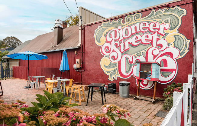 A mural on a red wall says Pioneer Street.