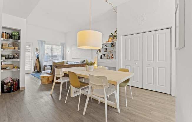 a dining room and living room with a table and chairs