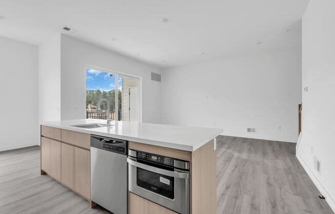 A modern kitchen with a stainless steel dishwasher and oven at The Franklin Marlboro Apartments, New Jersey