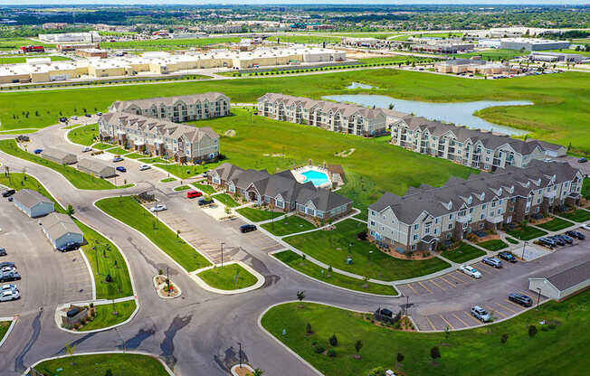 A drone view of an apartment community with a pool at Stoney Pointe Apartment Homes, Kansas, 67226