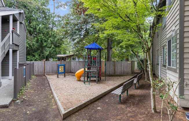 a play yard with a swing set and a playground