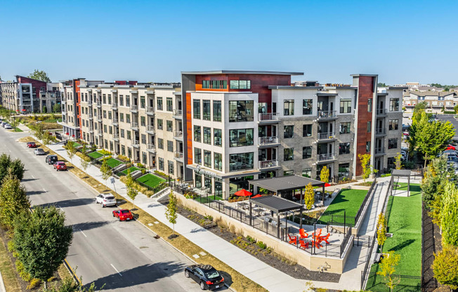 an aerial view of a row of apartment buildings on a city street