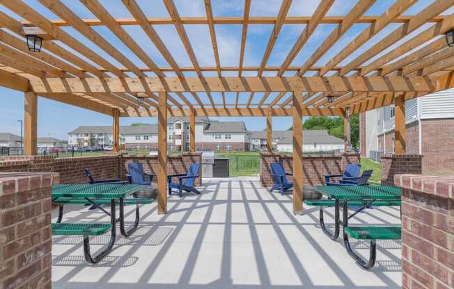 Crossing at Grove Citys clubhouse patio with green picnic tables