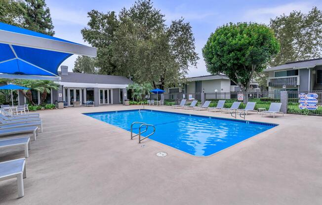 a pool with a blue umbrella