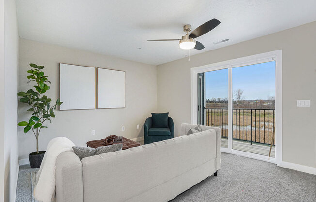 Living Room Leads To Private Balcony at Meadowbrooke Apartment Homes in Kentwood, MI 49512