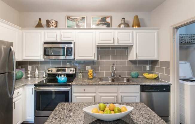 This is a photo of the kitchen in the 826 square foot 1 bedroom , 1 bath apartment at The Brownstones Townhome Apartments in Dallas, TX.