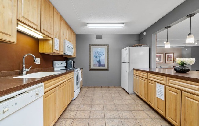 a kitchen with wooden cabinets and a sink and a refrigerator