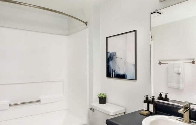 A white toilet sits next to a sink in a bathroom.