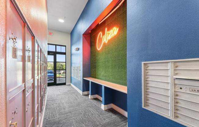 a hallway with a coca cola neon sign on the side of a building