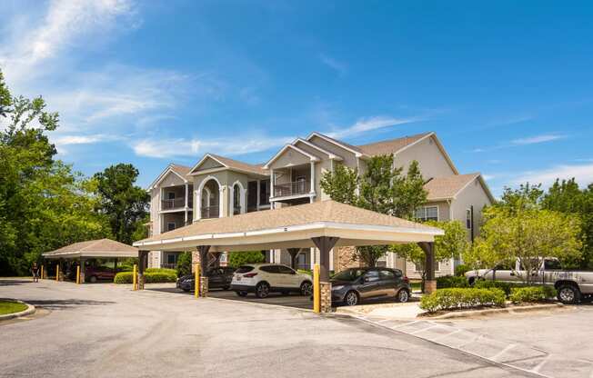 Covered parking spaces by the apartment buildings at Angel Landing Apartment Homes in Pensacola, FL