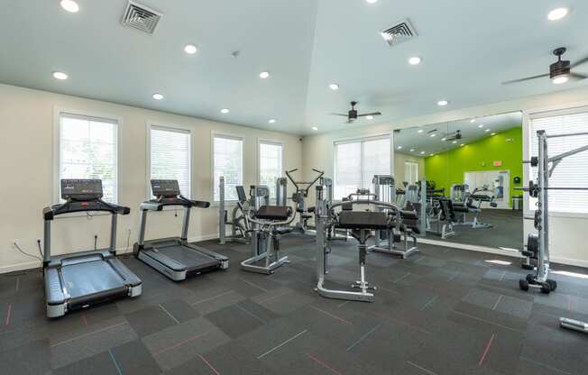 a gym with treadmills and other exercise equipment