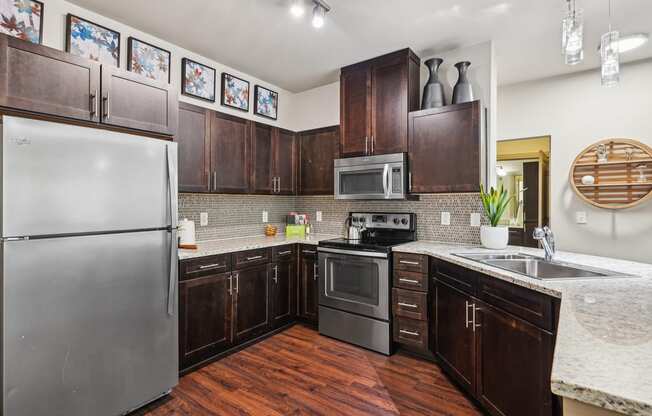 a kitchen with stainless steel appliances and wooden cabinets