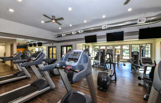 Fitness Club including TVs and Cardio and Weight Training at Pointe Royal Townhome Apartments, Overland Park, KS 66213
