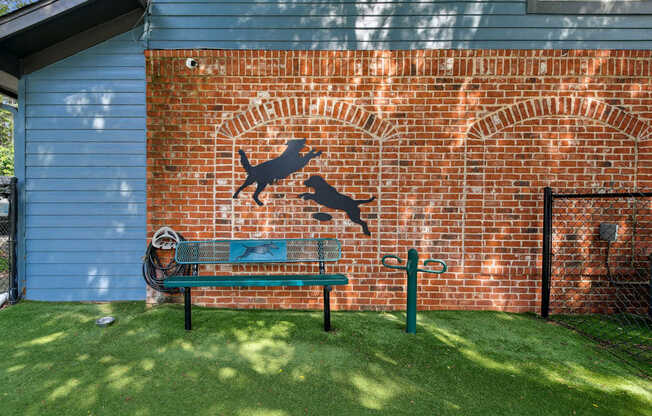 A dog silhouette is painted on a brick wall.