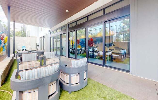 A modern outdoor seating area with a curved bench and a table.