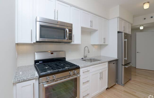 A kitchen with white cabinets and stainless steel appliances at 603 Concord Apartments, Cambridge 02138