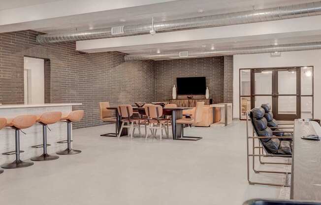 the lobby of a building with tables and chairs