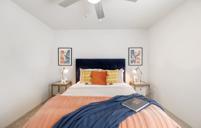 a bedroom with a large bed and a ceiling fan