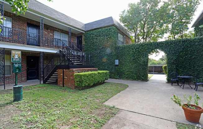 A building with a green lawn in front of it.