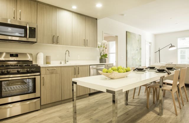 Kitchen with stainless steel appliances and dining area