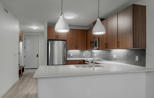 Dark Cabinet Kitchen with white pendants lighting