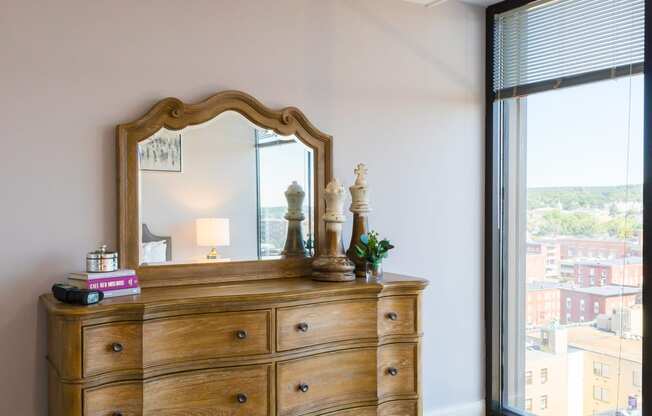 a bedroom with a dresser and mirror