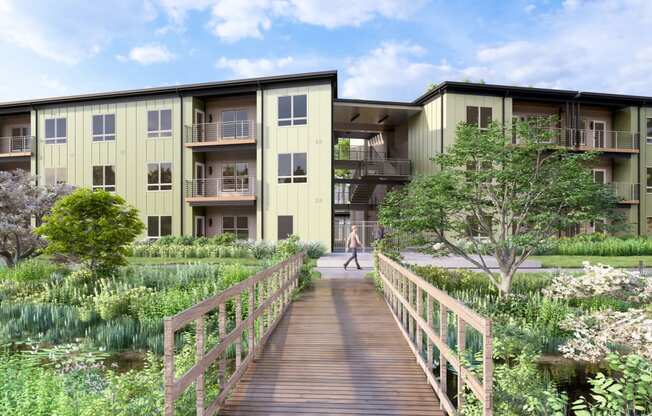 a bridge over a pond in the center of an apartment complex at Boardwalk at Research Park, Huntsville, 35811