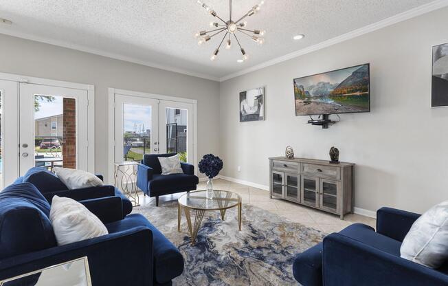 a living room filled with furniture and a window