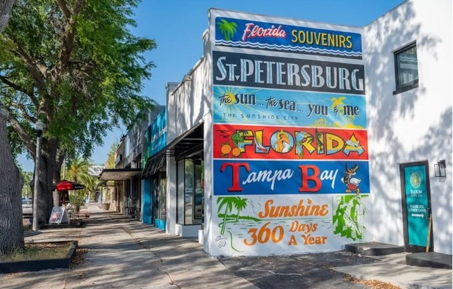 A wall with a sign that says "Florida Souvenirs St. Petersburg" and "Tampa Bay".
