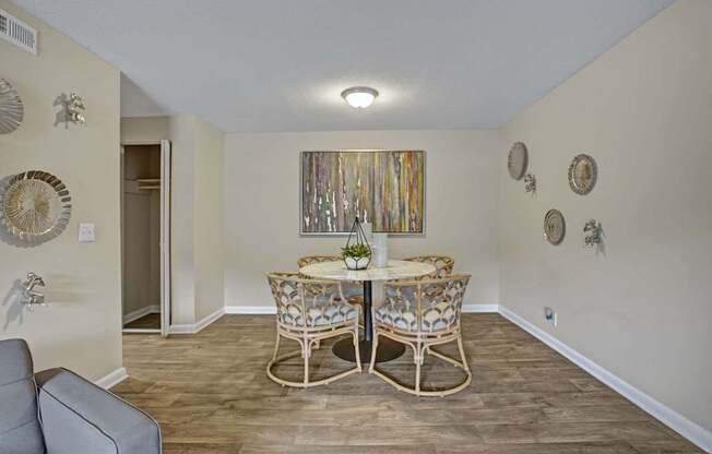 A dining room with a table and chairs.