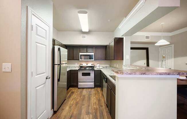 A kitchen with a white door and a white counter.