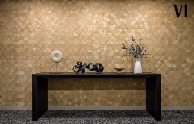 a room with a table and a vase and geometric wall tiles at The Lucy Boise Apartments, Idaho, 83702